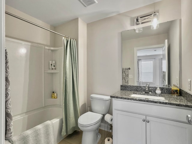 full bathroom with shower / tub combo with curtain, tile patterned flooring, vanity, and toilet