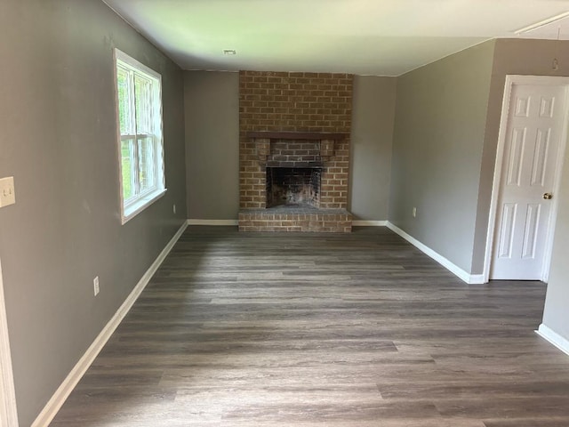 7713 Suzanne Dr, North Charleston, SC 29418 - unfurnished living room featuring wood finished floors, baseboards, a fireplace, and attic access