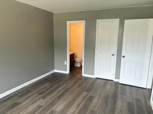7713 Suzanne Dr, North Charleston, SC 29418 - unfurnished bedroom with dark wood-type flooring, baseboards, and ensuite bathroom