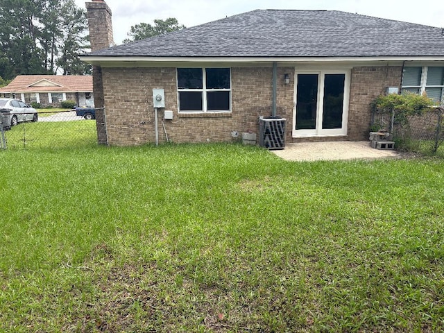 7713 Suzanne Dr, North Charleston, SC 29418 - back of property with roof with shingles, a chimney, brick siding, and central AC unit