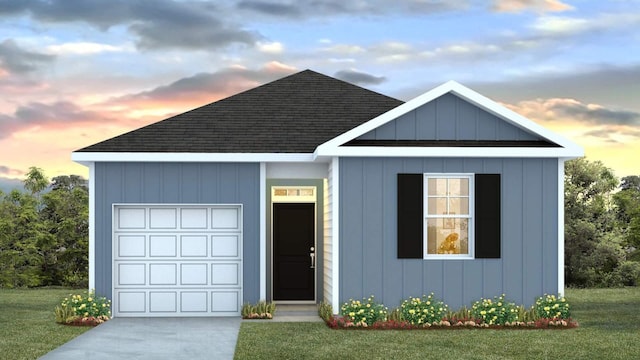 view of front of house featuring a yard, board and batten siding, an attached garage, and roof with shingles