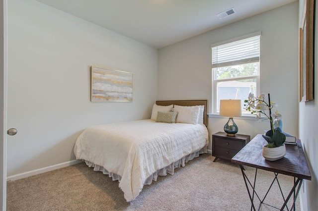 bedroom with light colored carpet, visible vents, and baseboards