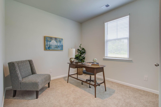 office space with baseboards, visible vents, and light colored carpet