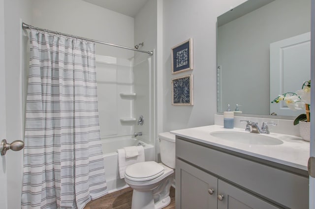 full bathroom featuring toilet, shower / bath combo, wood finished floors, and vanity