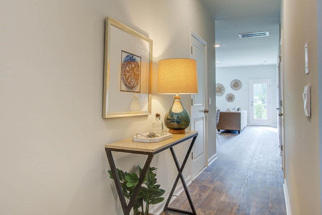 corridor featuring visible vents and wood finished floors