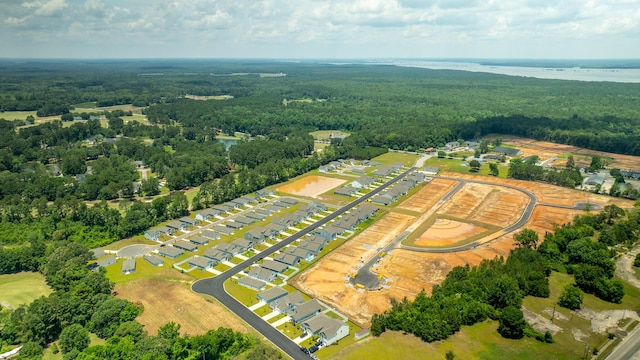 aerial view featuring a water view, a residential view, and a view of trees