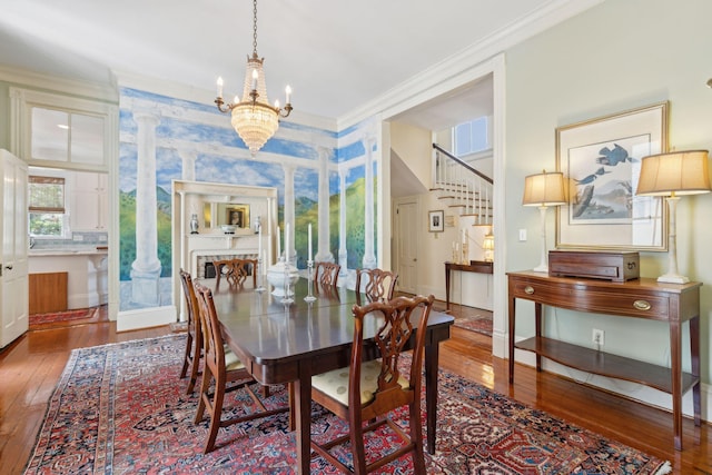 dining room with a chandelier, ornamental molding, and wood-type flooring