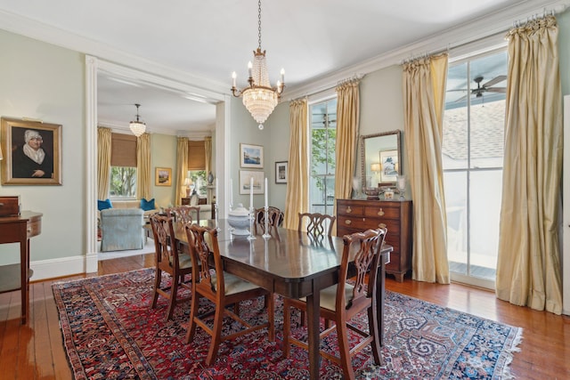 dining area featuring an inviting chandelier, hardwood / wood-style flooring, baseboards, and ornamental molding