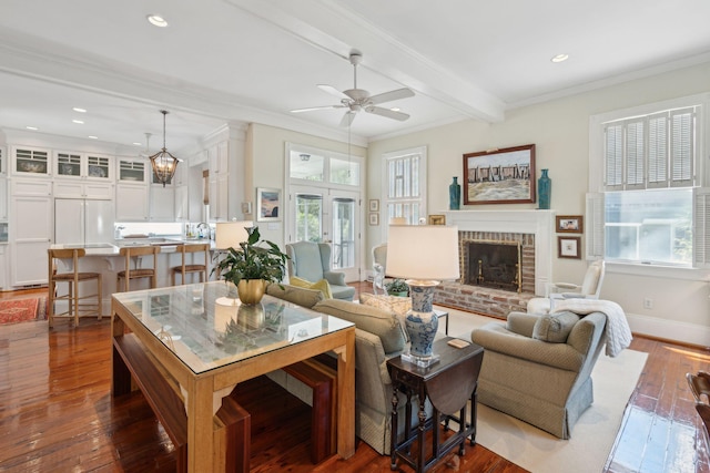 living room with a fireplace, a ceiling fan, ornamental molding, and recessed lighting