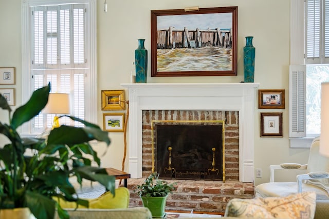 living area with a brick fireplace