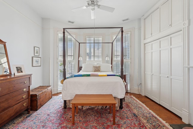 bedroom with a ceiling fan, visible vents, and light wood-style floors