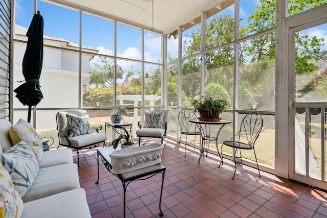 sunroom / solarium featuring plenty of natural light and an outdoor living space