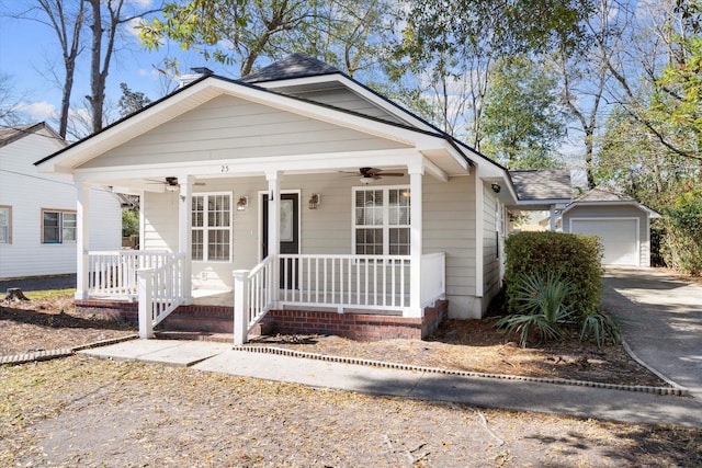 bungalow featuring a shingled roof, a porch, a garage, driveway, and a ceiling fan