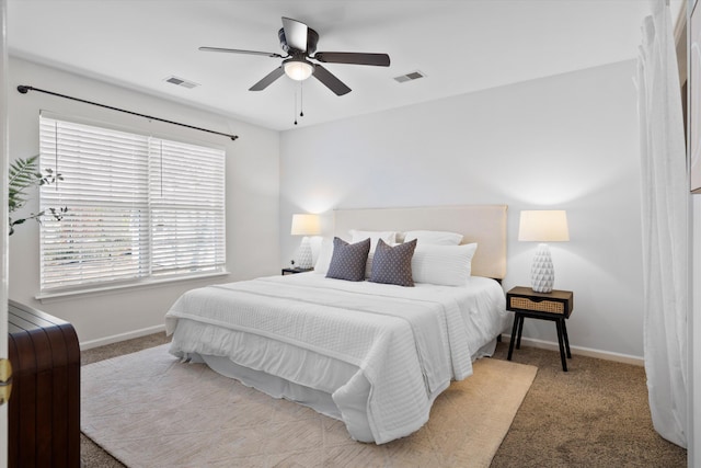 bedroom with light carpet, visible vents, and baseboards