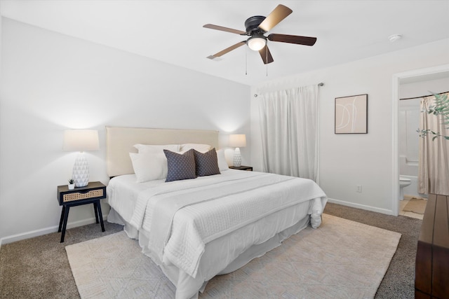 bedroom with light carpet, connected bathroom, a ceiling fan, and baseboards