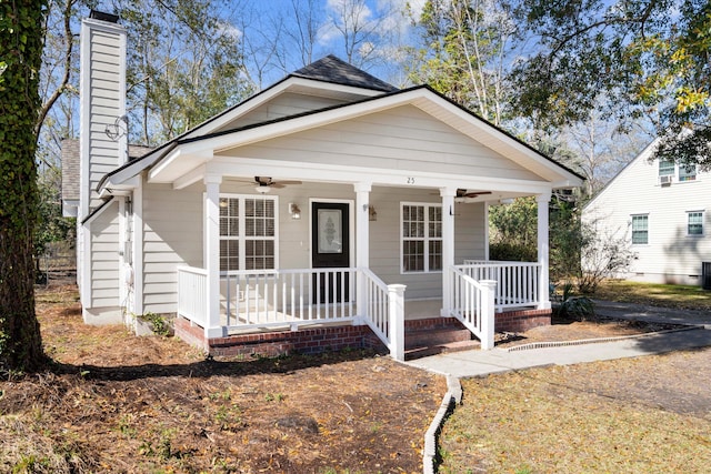 bungalow-style house featuring covered porch, a chimney, and a ceiling fan