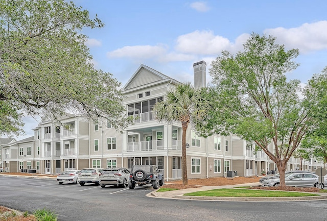 130 River Landing Dr Unit 2310, Daniel Island, SC 29492 - view of building exterior with uncovered parking, cooling unit, and a residential view