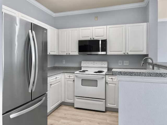 kitchen with appliances with stainless steel finishes, sink, white cabinets, crown molding, and light hardwood / wood-style flooring