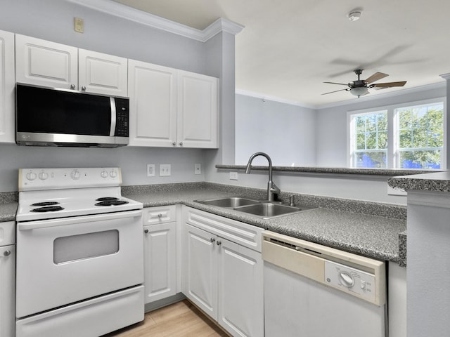 kitchen with white cabinetry, white appliances, and sink