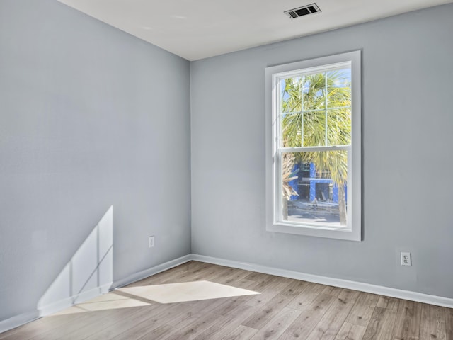 empty room with light hardwood / wood-style flooring