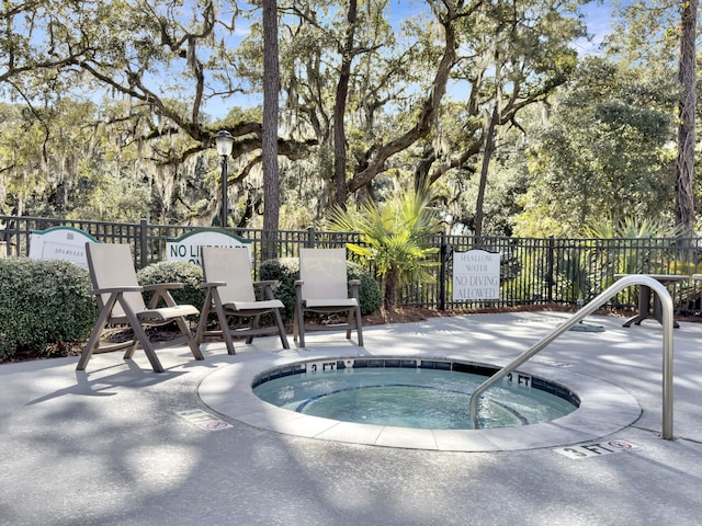 view of pool with a hot tub