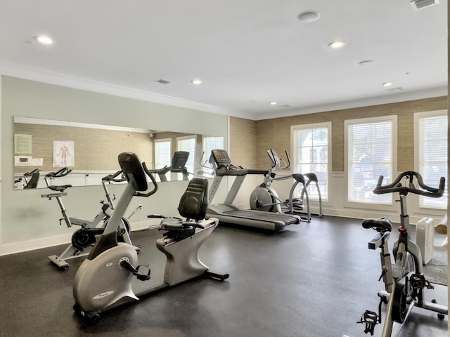 exercise room featuring ornamental molding