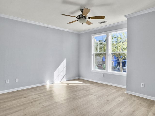 spare room with crown molding, light hardwood / wood-style floors, and ceiling fan