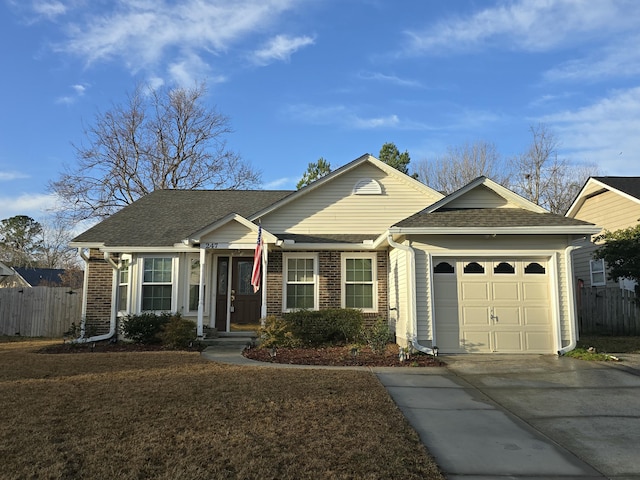 single story home with a garage and a front lawn