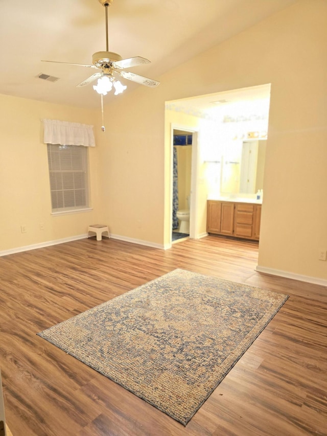 spare room featuring ceiling fan, lofted ceiling, and light hardwood / wood-style floors