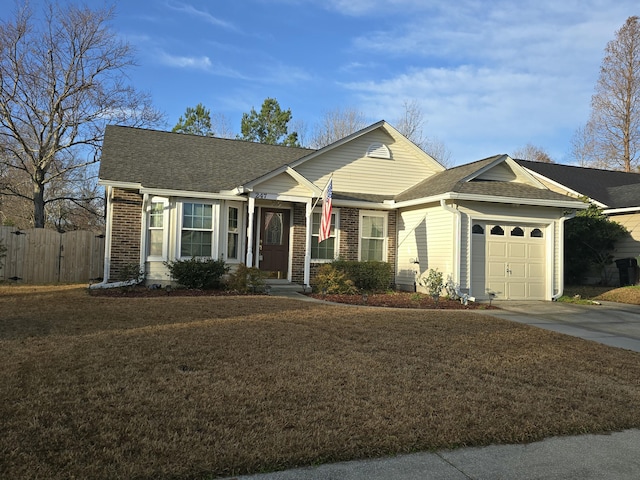 ranch-style house with a garage and a front lawn