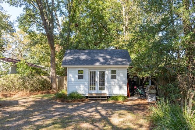 rear view of property featuring an outdoor structure