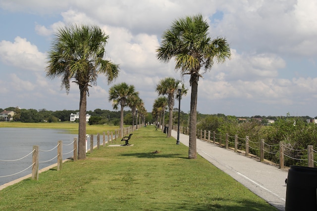 view of community featuring a water view and a lawn