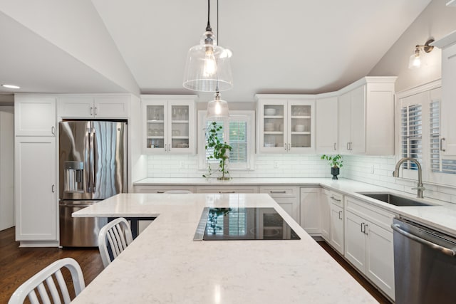 kitchen with appliances with stainless steel finishes, sink, and white cabinets