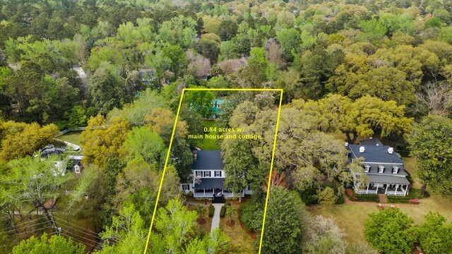 drone / aerial view featuring a forest view