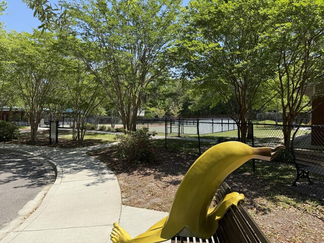 view of property's community with fence