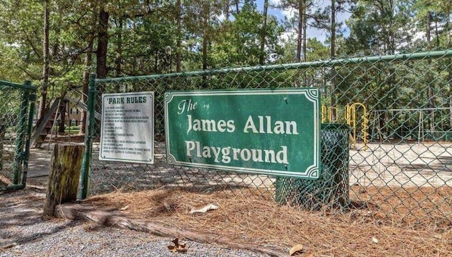 community / neighborhood sign with fence
