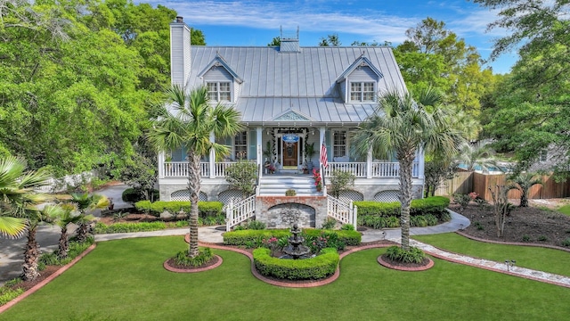 view of front of home with a front yard and covered porch