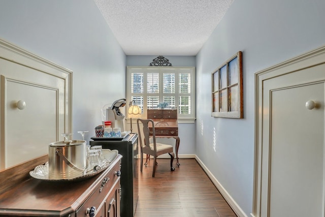 interior space featuring a textured ceiling and dark hardwood / wood-style flooring