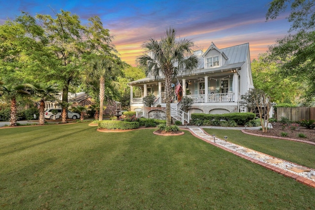 view of front of property with a lawn and covered porch