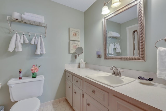 bathroom with vanity, toilet, and tile patterned floors