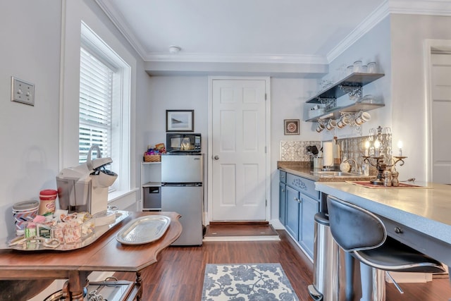 kitchen with stainless steel refrigerator, ornamental molding, and dark wood-type flooring