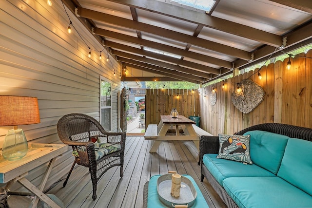 wooden terrace with an outdoor hangout area