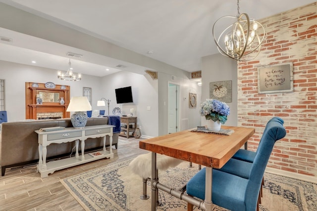 dining area featuring a notable chandelier and light wood-type flooring