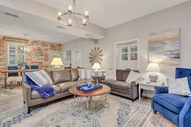 living room with a chandelier, plenty of natural light, and hardwood / wood-style floors