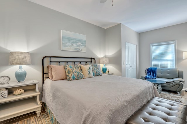 bedroom with ceiling fan, a closet, and hardwood / wood-style floors