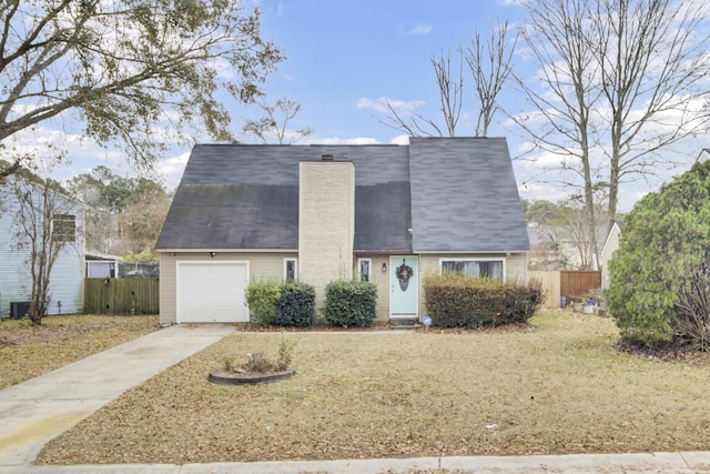 view of front of property with a garage and central AC