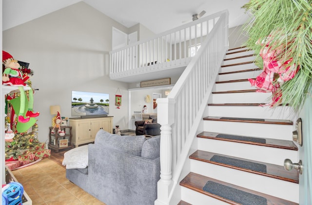 stairway with tile patterned flooring and lofted ceiling