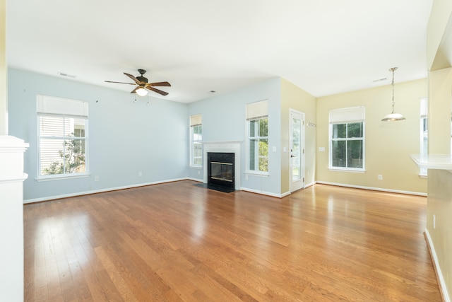 unfurnished living room with ceiling fan and light hardwood / wood-style flooring