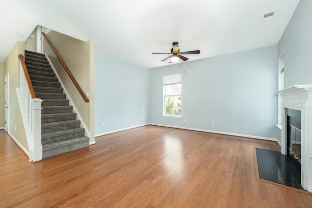 unfurnished living room with hardwood / wood-style flooring and ceiling fan