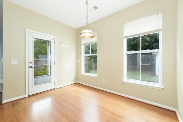 unfurnished room with light wood-type flooring